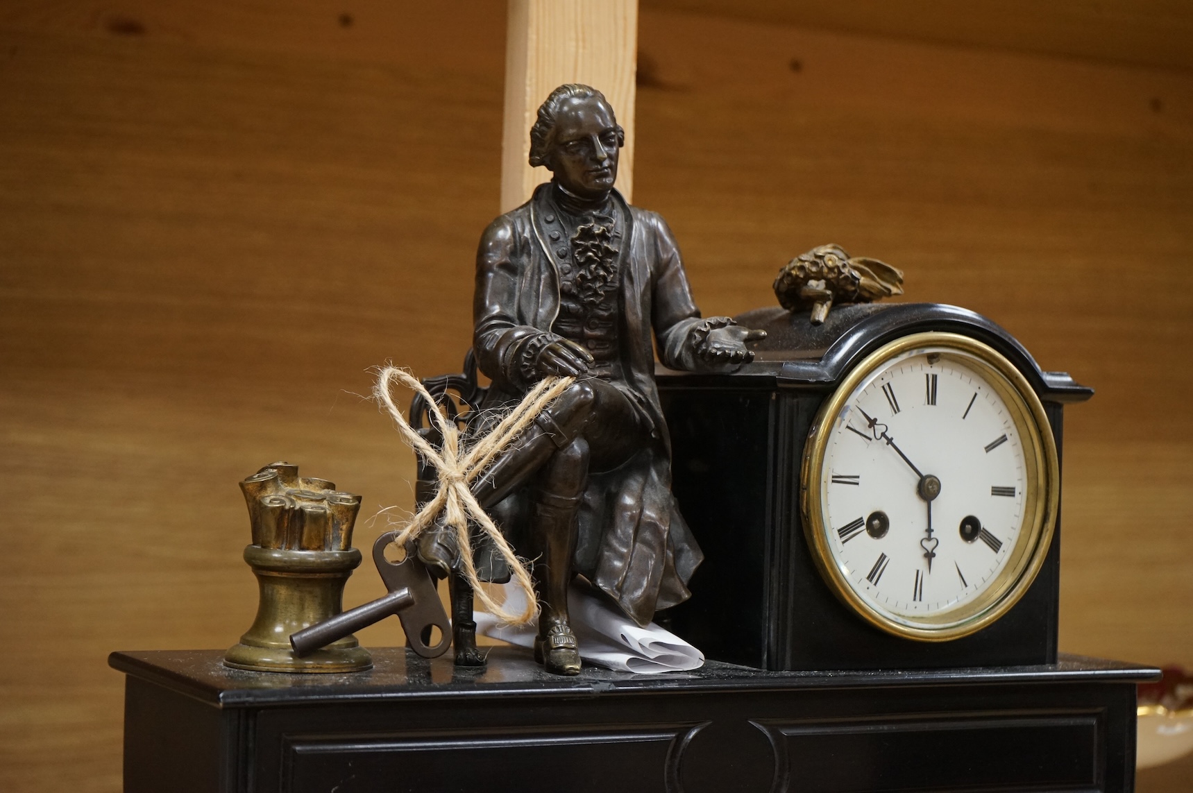 A 19th century French bronze and slate 8 day mantel clock, mounted with figure of Denis Diderot (1713-1784), 40cm wide